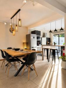 a kitchen and dining room with a wooden table and chairs at Villa Ptit Bouchon - En face de la Plage - Facing beach with Ocean views in Bouchon