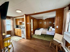 a kitchen and a bedroom with a bed in a room at Highland House and Cottages in Carroll