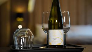 a bottle of wine and a glass on a table at Hotel Fatima in Trenčín
