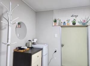 a kitchen with a refrigerator and a counter with plants at Maison Veluna in Seoul +21 photos