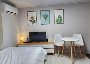 a bedroom with a desk and a bed and a table at Maison Veluna in Seoul