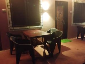 a room with a table and chairs and a television at Sanvi Resort Malvan in Malvan