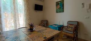 a dining room with a table and chairs and a television at Casa Margherita in Casa Santa