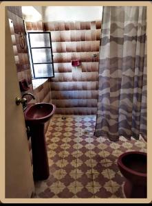 a bathroom with a sink and a toilet at Hostal Casa Margarito in Guadalajara +16 photos
