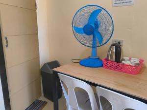 a blue fan sitting on top of a table at Elyu Seaside in San Juan