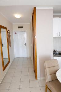 a living room with a mirror and a kitchen at Sea View Apartment Rafailovići in Rafailovici +3 photos