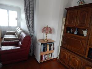 a living room with a couch and a book shelf at Côte Landaise in Tarnos