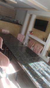 a dining room with a table and chairs at Casa Ruja in Ocna Sibiului