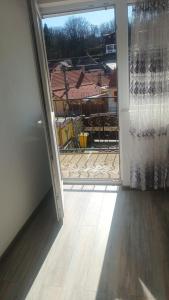 an open door with a view of a house at Casa Ruja in Ocna Sibiului