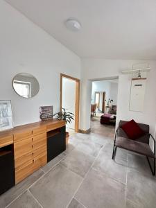 a living room with a desk and a chair at Modern apartment with space for 6 in Weißenfels +8 photos
