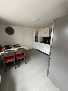 a kitchen and dining room with a table and chairs at Ferienwohnung in der Langenau in Lichtenfels +4 photos
