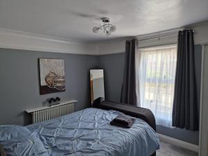 a bedroom with a bed and a window at Carisbrooke Mill Cottage in Newport