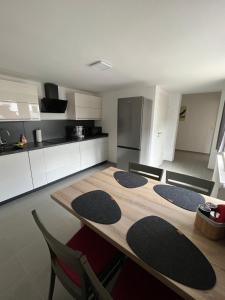 a kitchen with a table and chairs in a room at Ferienwohnung in der Langenau in Lichtenfels