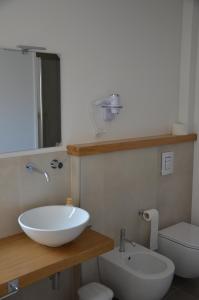 a bathroom with a sink and a toilet at La Porta Rossa House in Castelbuono