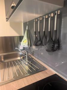 a kitchen with utensils hanging on a wall at Pure comfort in Entrelacs