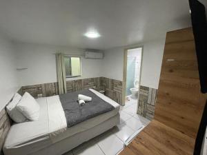 a bedroom with a large bed and a bathroom at Pousada vila bela in Porto De Galinhas +46 photos