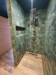 a bathroom with a shower with green tiles at Surf & Sauna Bud House in Longeville-sur-Mer +12 photos