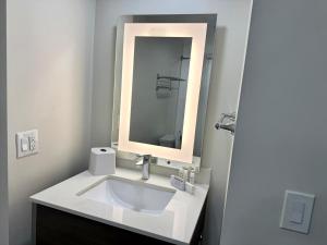 a bathroom with a white sink and a mirror at Lodge at Mill Creek Pigeon Forge in Pigeon Forge +19 photos