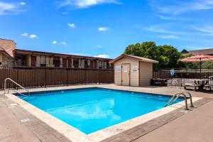 a swimming pool with a patio and an umbrella at Lodge at Mill Creek Pigeon Forge in Pigeon Forge