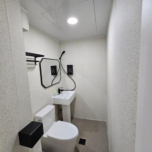 a bathroom with a white toilet and a sink at AnJin's Guest House in Mokpo +27 photos