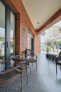 a patio with a table and chairs and a brick wall at Panorama Boutique Hotel in Tbilisi City