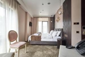 a hotel room with a bed and a window at Panorama Boutique Hotel in Tbilisi City