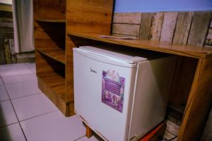 a white refrigerator in a kitchen with a counter at Pousada vila bela in Porto De Galinhas