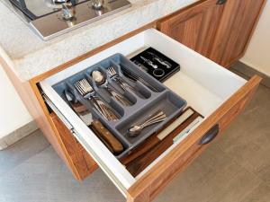 a drawer in a kitchen with utensils in it at Loft Alegria in Avaré