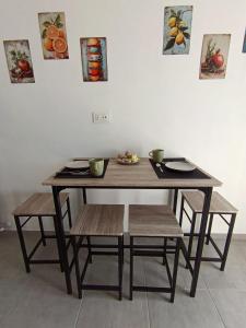a wooden table with two chairs and two bowls on it at Casa RAFFAELLO in Vigevano