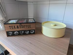 a tea and coffee box and a candle on a table at Casa RAFFAELLO in Vigevano +6 photos