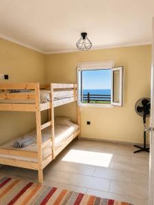 a bunk bed room with two bunk beds and a window at Ouranoupolis View Point in Ouranoupoli +42 photos