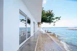 a building on the beach next to the water at Antuwanga reef resort in Moalboal