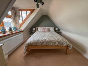 a bedroom with a bed in a attic at Shop Cottage, Findhorn in Findhorn
