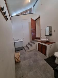 a bathroom with a staircase and a sink and a toilet at Valhalla Mentawai in Katiet +40 photos
