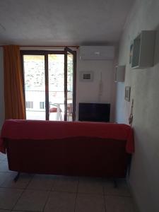 a room with a bed with a red sheet on it at LadyBird and Turtle in Podglavica