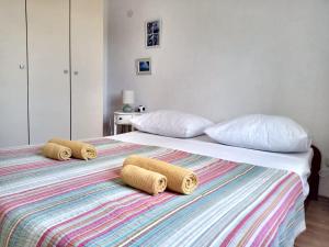 a bedroom with two beds with towels on them at LadyBird and Turtle in Podglavica
