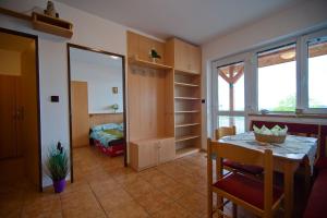 a room with a dining table and a bedroom at Apartmány Dřevařská Benecko in Benecko