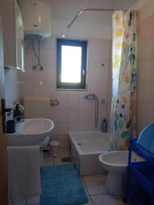 a bathroom with a sink and a tub and a toilet at LadyBird and Turtle in Podglavica +81 photos