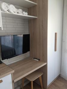 a living room with a television on a table at Aquamarine Centrale in Kavála