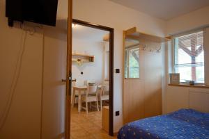 a bedroom with a bed and a dining room at Apartmány Dřevařská Benecko in Benecko +13 photos