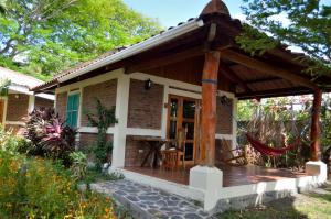 a porch of a house with a wooden deck at Hotel Villa Paraiso in Santo Domingo