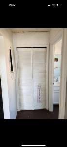 a white garage door with a sign on it at Pixie hollow single vacation retreat resort dwelling in Orlando +5 photos