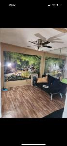 a living room with a ceiling fan and a couch at Pixie hollow single vacation retreat resort dwelling in Orlando