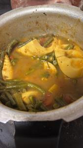 a pot of food with green beans and vegetables at Pixie hollow single vacation retreat resort dwelling in Orlando