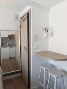 a kitchen with a counter and stools in a room at Aquamarine Centrale in Kavála