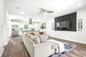 a living room with a couch and a tv at The Ultimate View House in Dallas