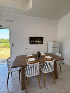 a dining room with a wooden table and chairs at Modern Villa in Lesvos in Apidias Lakos