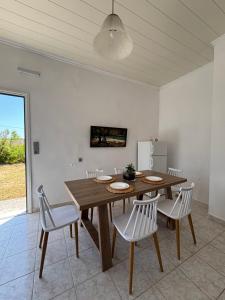 a dining room with a wooden table and chairs at Modern Villa in Lesvos in Apidias Lakos
