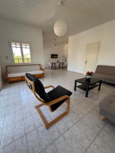 a living room with a chair and a couch at Modern Villa in Lesvos in Apidias Lakos +15 photos