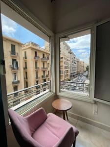 a room with a chair and a large window at Le caire Hotel & suits in Cairo